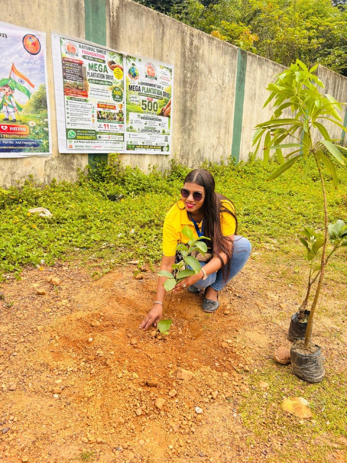 Volunteers planting trees together on our environment drive